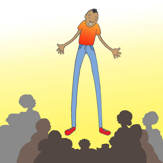 A very tall man standing in front of a crowd of people.