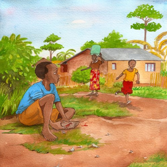 A boy sitting holding his injured foot.