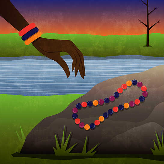 Someone picking up a necklace sitting on a rock near a river.