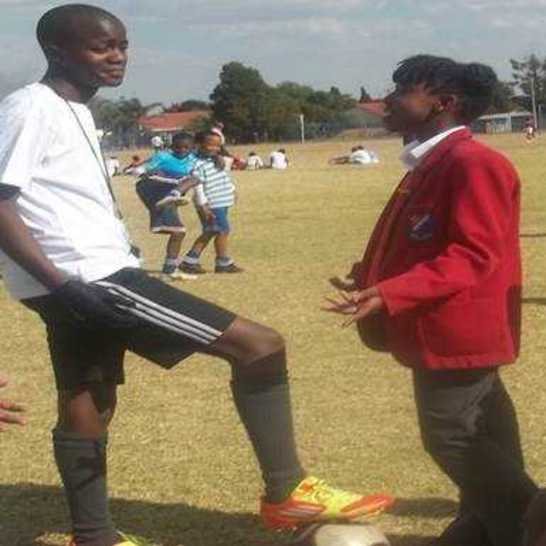 A girl talking with a soccer coach.