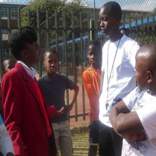 A girl talking with a soccer coach.