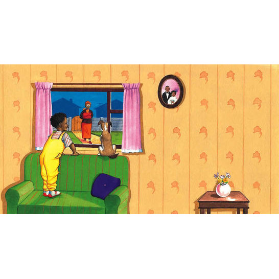 A boy standing on a sofa looking out of a window and a dog sitting on the windowsill next to him.